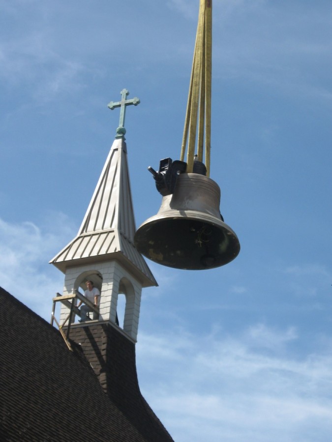 Restored Meneely Bell from 1911 is hoisted into restored steeple